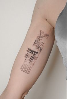 a woman's arm with a tattoo on it that has an image of a table and flowers