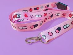 This adorable pink pill lanyard is perfect to match your Menhera Kei outfit when you go to conventions or fashion events! It's cute pill design also makes it a fun gift for spoonies, nurses, doctors, and fans of Japanese alternative fashion. The lanyard has a plastic clasp at the back (this is not quick release, because my manufacturer made a mistake in production). It has a sewn end and a metal clasp for adding an ID card, event pass, and/or fun keyrings. The lanyard measures 50cm from back fastening to end of metal clasp. Menhera Fashion Outfit, Yamikawaii Accessories, Menhera Accessories, Menhera Kei Aesthetic, Pink Lanyard With Key Leash For Gift, Sanrio Lanyard, Japanese Alternative Fashion, Menhera Kei, Medical Fashion