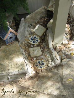 an outdoor area with rocks and stones on the ground