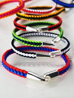 six different colored bracelets with metal clasps