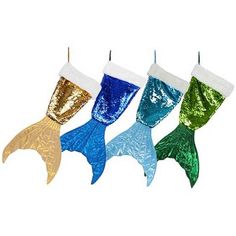 three mermaid tail christmas stockings hanging from a hook on a white background with the colors of blue, green, gold and silver