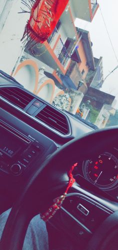 the interior of a car with steering wheel and dashboard