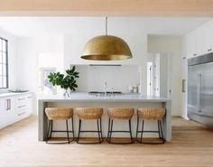 three stools sit in front of the kitchen island