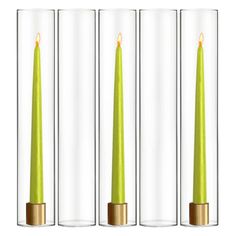 three candles in glass vases with gold rimmed bases, one green and the other yellow