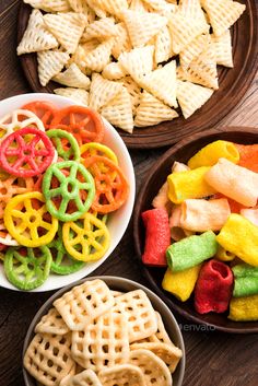 three bowls filled with different types of snacks