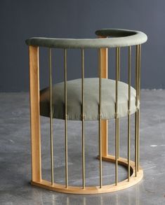 a chair with a cushion in the middle of it and a metal cage around it