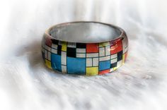 a colorful ring sitting on top of a white surface