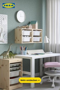 a child's desk and chair in front of a wall with a clock on it