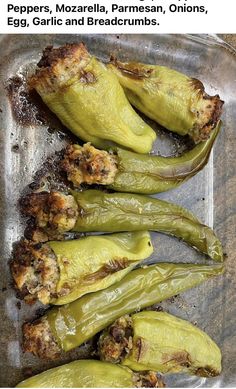 some green peppers sitting on top of a metal pan filled with meat and seasoning