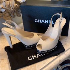 Gorgeous Chanel Leather Open Toe And Sling Back Heels. Light Beige Clair With Black Front Bottom With Silver Tone Chain Accent. Only Signs Of Wear Is On The Soles. Also A Small Scratch On The Side Heel Of The Right Shoe. See Photo. Euc. Comes With Box And Dust Covers. Chanel Open Toe, Shoes Chanel, Sling Back Heels, Open Toe Heels, Front Bottoms, Selling On Poshmark, Sling Back, Chanel Shoes, Dust Cover