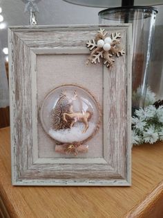 a christmas ornament in a frame on a table