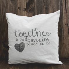 a white pillow with the words together is our favorite place to be written on it