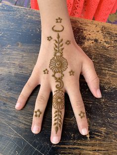 a woman's hand with henna tattoos on it