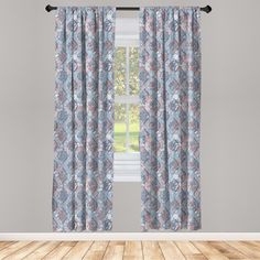 an open window with blue and pink floral curtains in front of a wooden flooring area