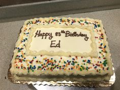 a birthday cake with white frosting and sprinkles