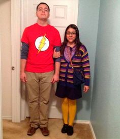 a man and woman standing in front of a door with the flash symbol on it