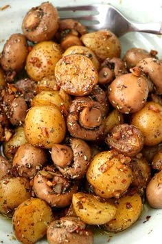 a close up of a plate of food with mushrooms and seasoning on it,