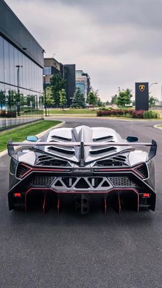 a black and white sports car parked in front of a building