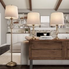 a living room filled with furniture and two lamps on top of a wooden table in front of a fireplace