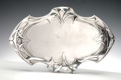 a silver plate sitting on top of a white table