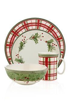 a set of christmas dishes with holly designs