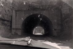 a car driving through a tunnel on the road