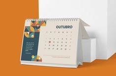 a calendar with an abstract design on the front and back cover, sitting next to a white box