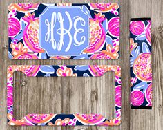 the monogrammed license plate cover is shown in blue and pink with an ornate floral design