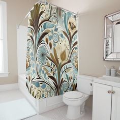 a bathroom with a floral shower curtain next to a toilet