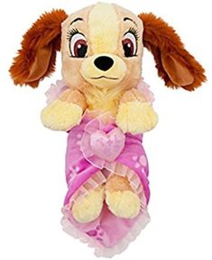 a stuffed dog with a pink bow around it's neck