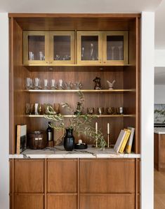 the dining room's bar is a variation of the kitchen design that places more enphasing on the first son between what and brass