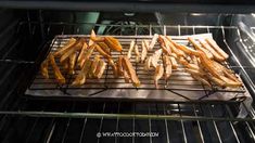 french fries are being cooked in an oven