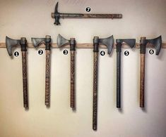 several different types of hammers hanging on a wall