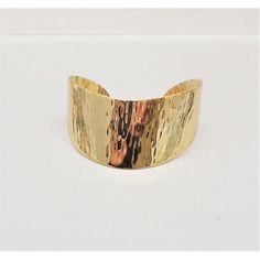 This is part of Chairish’s Costume Jewelry assortment.  Goldtone hammered crescent shaped slide on cuff bracelet. Marked "Napier." Center: 1 1/8 inches across. Interior circumference: about 6 3/4 inches. Opening: 15/16 inches. It can bend a bit to it to get your wrist inside. Condition: Very good; very minimal wear only noticeable upon very close inspection. Dates to about 1976 based on similar cuffs advertised in that year. Modern Hammered Cuff Bracelet For Formal Occasions, Classic 14k Gold Hallmarked Cuff Bracelet, Hammered Metal Cuff Bracelet, Formal Hammered Cuff Bracelets, Formal Hammered Cuff Bracelet, Modern Hammered Metal Cuff Bracelet, Antique Hallmarked Yellow Gold Cuff Bracelet, 14k Yellow Gold Tarnish-resistant Cuff Bracelet, Vintage Yellow Gold Hallmarked Cuff Bracelet