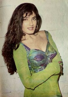 a woman in a green shirt posing for the camera