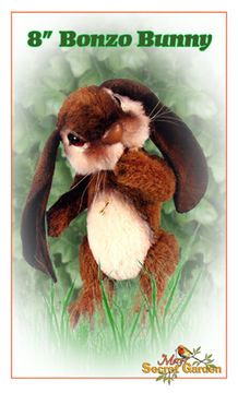 a stuffed animal bunny sitting on top of some green grass with the words 8 / 7 bonzo bunny