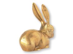 a gold colored rabbit figurine on a white background