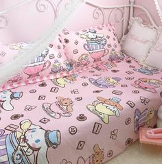 a child's bed with pink and white comforter, teddy bear pillowcases and pillows