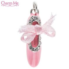 a pink charm with a bow on it