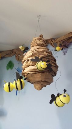 several bees are hanging from the ceiling