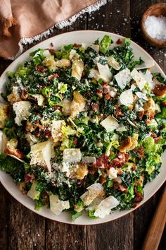 a white bowl filled with salad on top of a wooden table