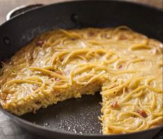 a skillet with some food in it on a table and one piece is missing