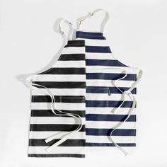 two aprons with different designs on them, one is black and the other is white