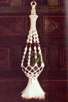 a white crocheted chandelier hanging from a wooden door