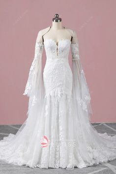 a white wedding dress on a mannequin with long sleeves and sheer laces