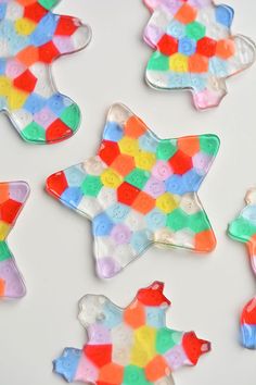 several decorated cookies sitting on top of a white table