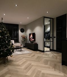 a living room filled with furniture and a christmas tree