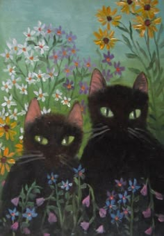 two black cats sitting in front of flowers