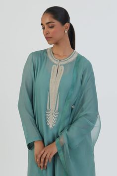 Blue kurta featuring placed thread embroidered floral vine and paisley motifs, highlighted by sequin embellishments in an asymmetric silhouette. Comes with silk pant. - Aza Fashions Paisley Motifs, Silk Pant, Blue Kurta, Pant For Women, Pant Women, Women Kurta, Floral Vine, Silk Pants, Fashion App