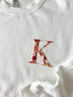 a t - shirt with the letter k painted on it